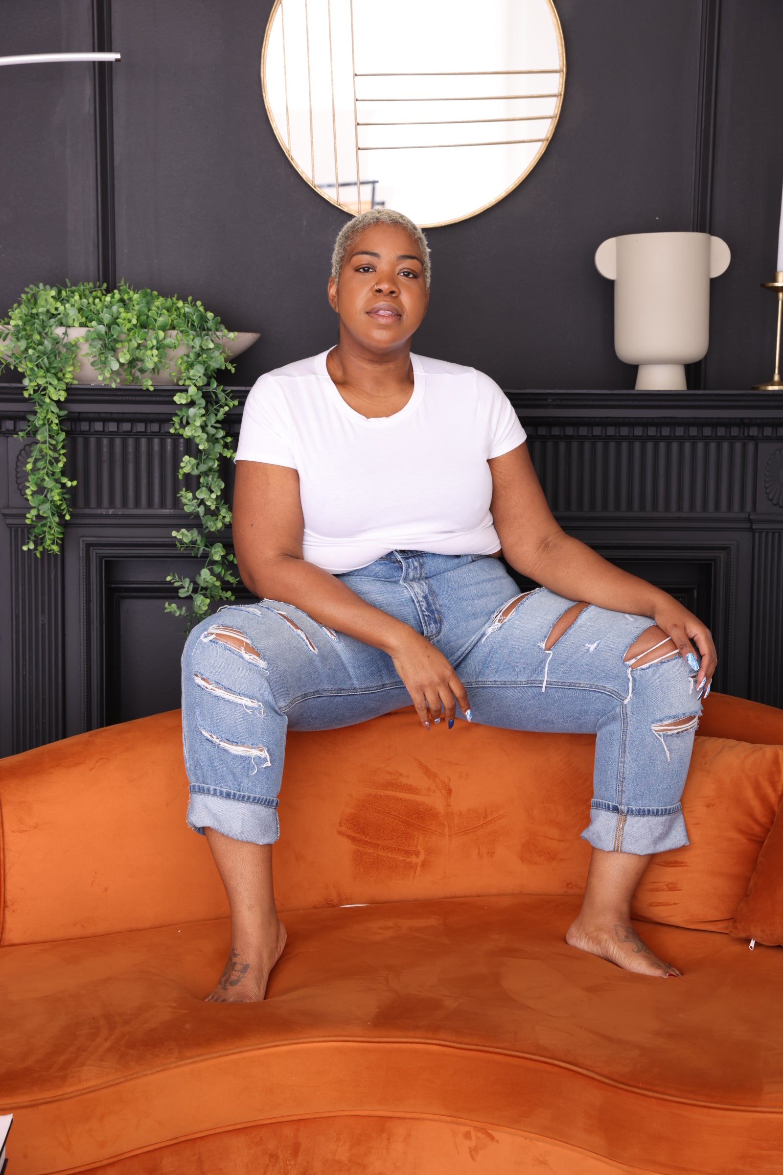 “Mid-rise plus-size boyfriend jeans in rigid 100% cotton denim, 30-inch inseam, with subtle distressed front-leg details.”