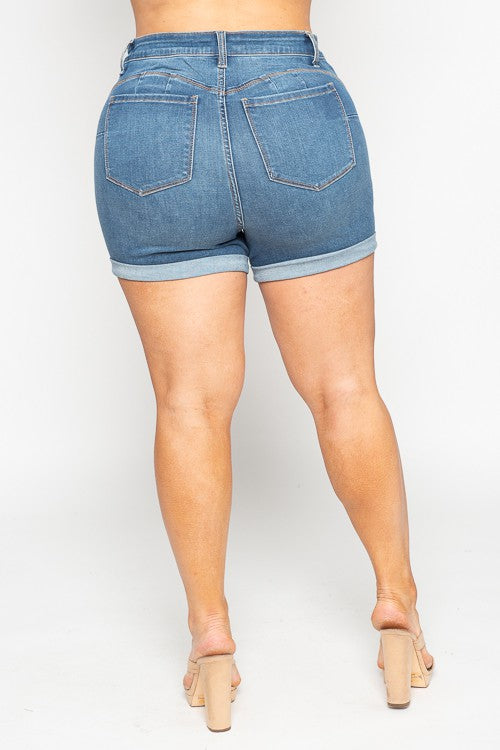 “High-rise plus-size denim shorts with 7-inch inseam, cuffed hem, and medium blue wash designed for comfort and style.”